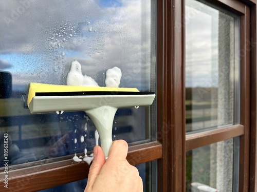 wash the glass on the window with a window cleaning scraper