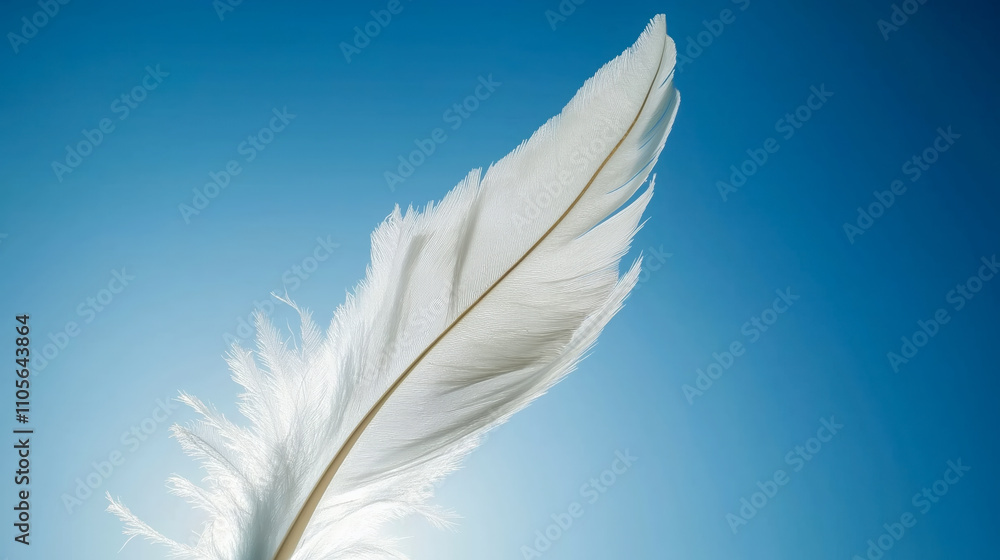 Obraz premium Feather glides gracefully against a stunning azure sky, capturing the essence of lightness and beauty in natures artistry.