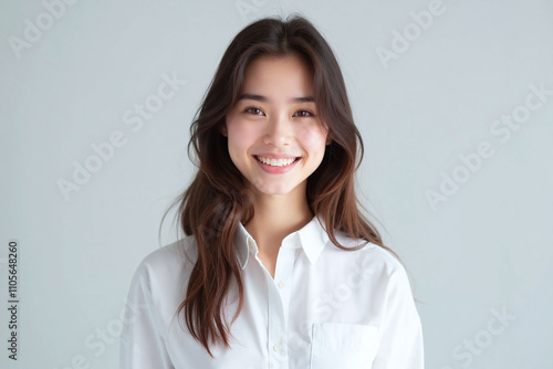 Young woman in white shirt with friendly expression