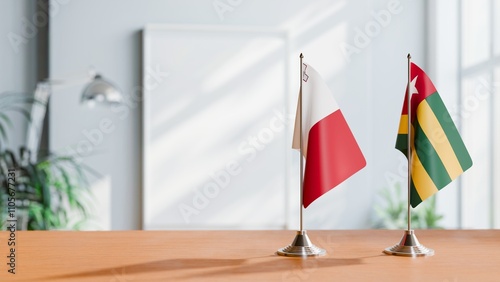 FLAGS OF MALTA AND TOGO ON TABLE photo