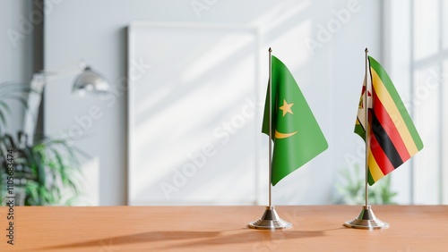 FLAGS OF MAURITANIA AND ZIMBABWE ON TABLE photo