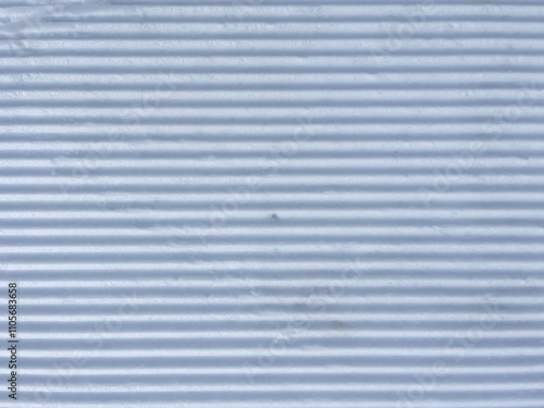 White and freshly groomed snow. Top view of snow prepared for snowboarding, skiing, nordic skiing, winter hiking, and other winter sports and activities.