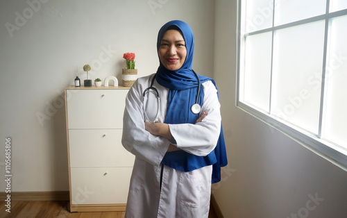 Asian Muslim Woman Doctor Smiling With Arms Crossed And Confident At Hospital