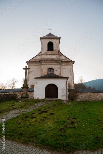 Obraz na płótnie A serene view of the Church of the Nativity of the Virgin Mary in the village of Mlynicky Dvur, showcasing its architectural beauty and peaceful rural surroundings w salonie