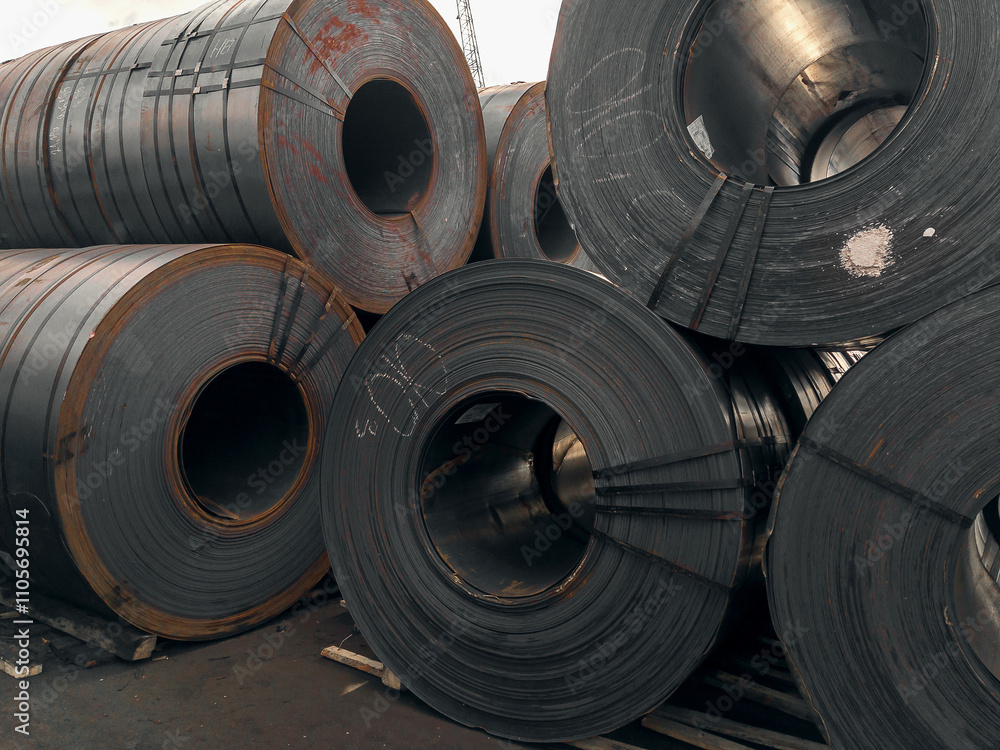 Steel rolls. A roll of sheet iron. Hot rolled steel rolls are stored outdoors. Sheet metal in the port. Steel rolls are available in stock. Rolls of steel sheet. Steel rolls. A roll of sheet iron. Hot rolled steel rolls are stored outdoors. Sheet metal in the port. Steel rolls are available in stock. Rolls of steel sheet.