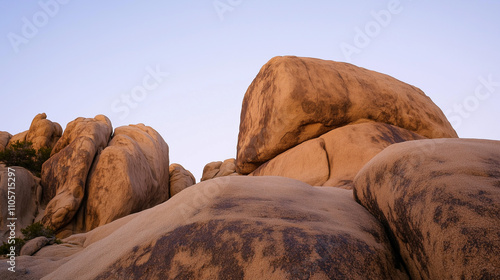 Rugged Beauty of Joshua Tree: Massive Granite Boulders in Golden Desert Landscape photo