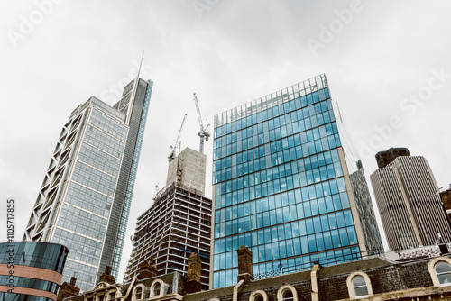 Skyline of Modern City with Construction Cranes photo