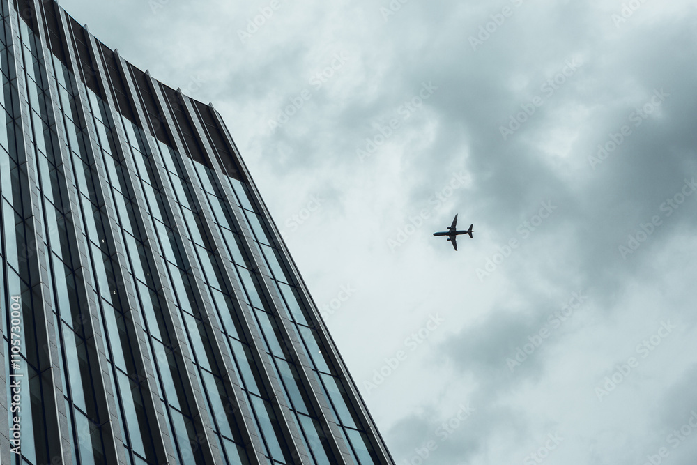 Skyscraper and Airplane in Cloudy Sky Skyscraper and Airplane in Cloudy Sky