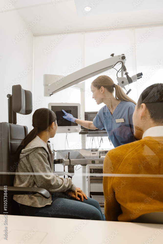 Female doctor explaining medical procedure to patient on screen at hospital Female doctor explaining medical procedure to patient on screen at hospital