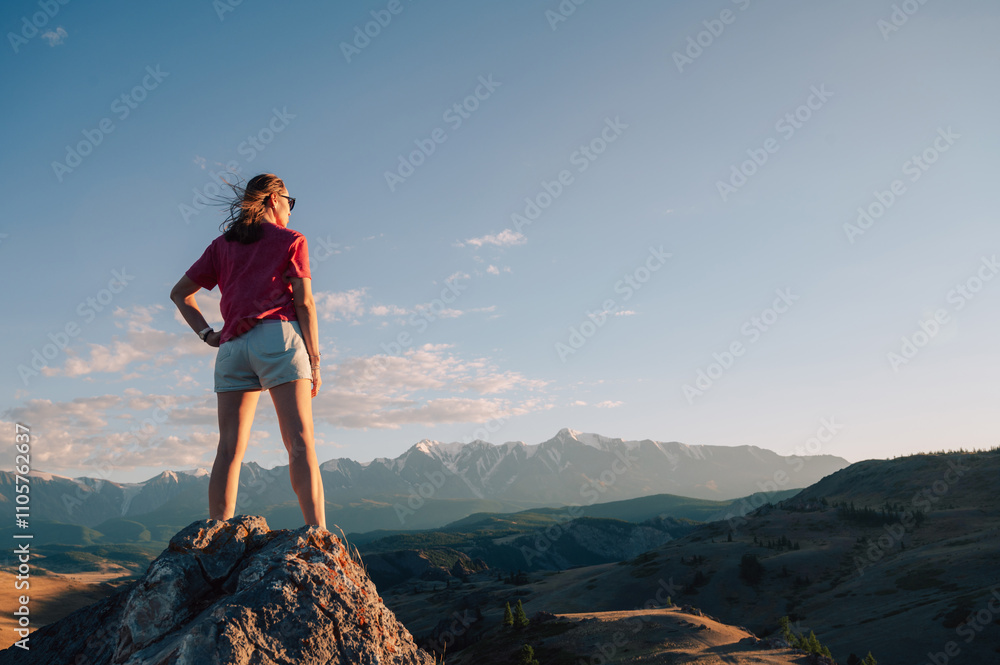 Fototapeta premium Woman Admiring Mountain Landscape at Sunset