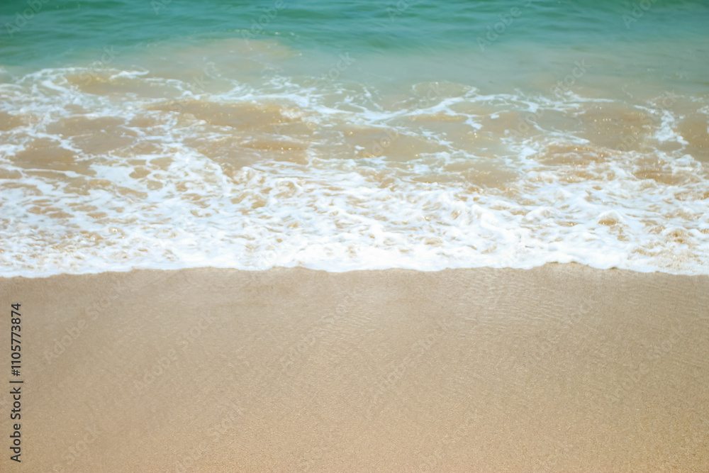 Soft waves of blue sea with foam on golden white sandy beach. Wave background Soft waves of blue sea with foam on golden white sandy beach. Wave background