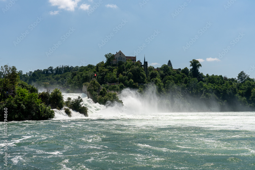 The Rhine Falls with Schloss Laufen on a beautiful summers day. Because of plenty of rain the days before, there is much water in the rhine, making the view even more spectacular. The Rhine Falls with Schloss Laufen on a beautiful summers day. Because of plenty of rain the days before, there is much water in the rhine, making the view even more spectacular.