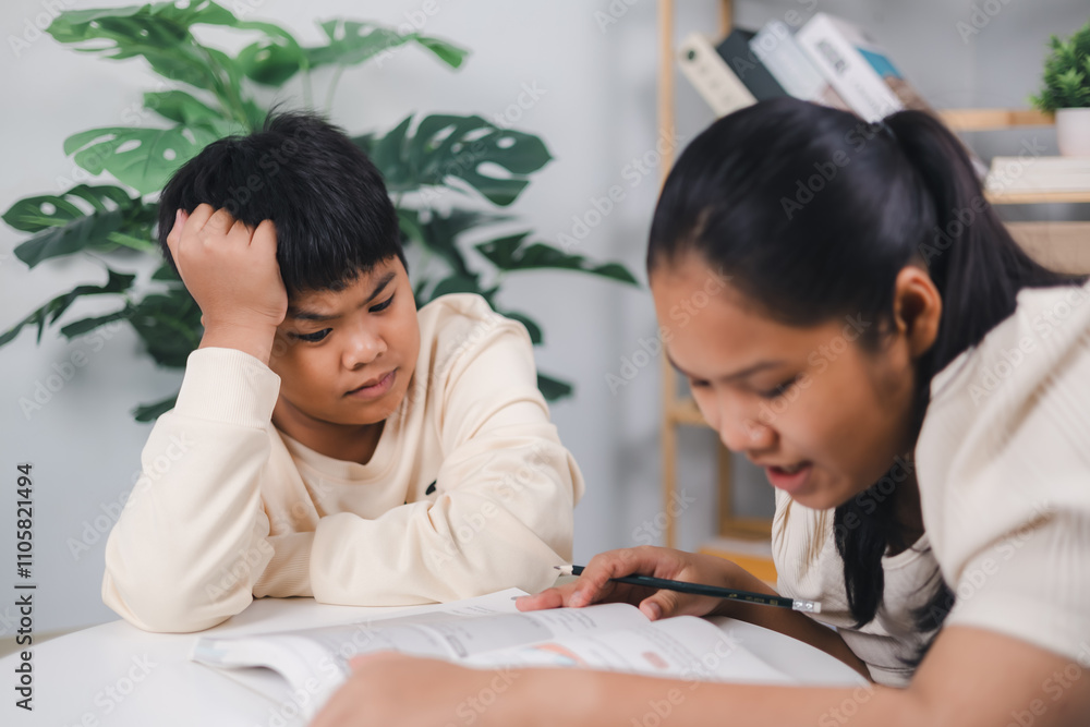 Sister helping boy writing lesson and learning to write, Female tutor helping little elementary school boy with homework during individual lesson at home, Education home school concept. Sister helping boy writing lesson and learning to write, Female tutor helping little elementary school boy with homework during individual lesson at home, Education home school concept.