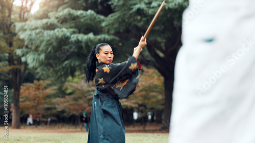 Wooden sword, Japanese woman and outdoor in training, exercise and sports for martial arts or aikido. Students, weapon and heritage with challenge, combat and practice as defense technique or bojutsu photo