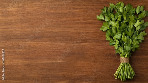 Fresh parsley bunch on a wooden surface, showcasing vibrant green leaves, perfect for culinary use or garnishing dishes.