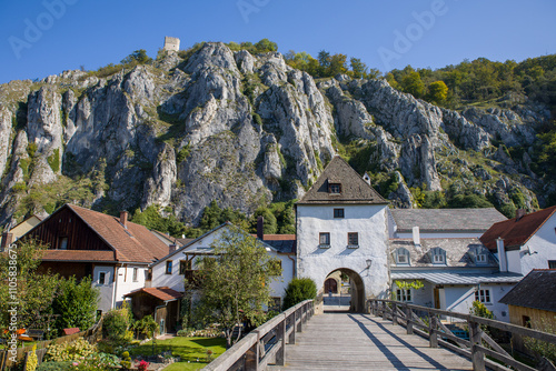 view of the old wooden bridge in Essing in the Altmuehl valley with sunshine and blue sky