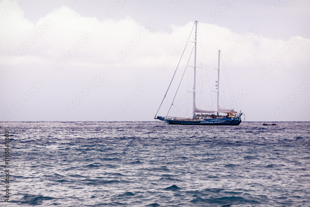Fototapeta premium Serene Sailboat on Tranquil Sea 