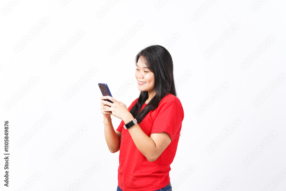 Smile while using smartphone Of Beautiful Asian Woman wearing red shirt Isolated On White Background Smile while using smartphone Of Beautiful Asian Woman wearing red shirt Isolated On White Background
