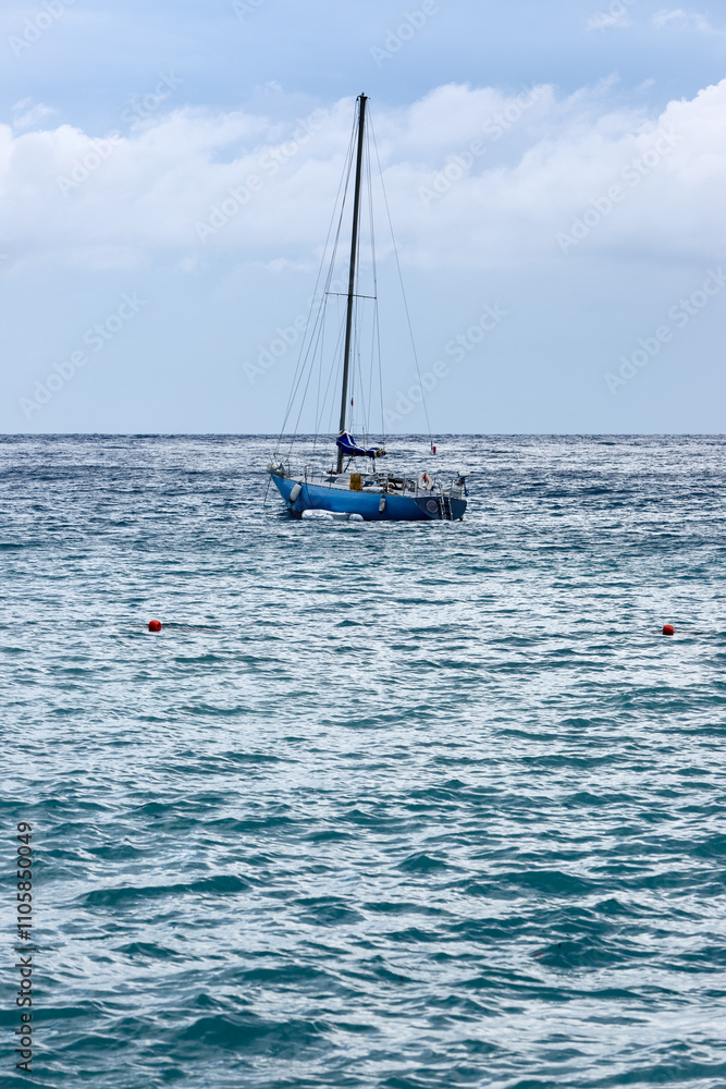 Naklejka premium Sailboat on Serene Ocean Waters