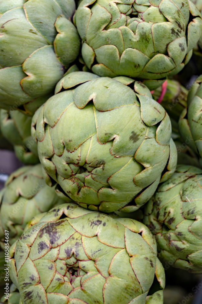 Fresh ripe green organic artichokes heads on local farmers market in Dordogne, France Fresh ripe green organic artichokes heads on local farmers market in Dordogne, France