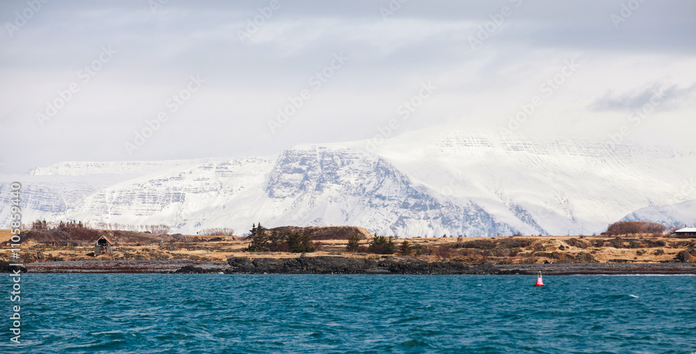 Panoramic landscape with small residential houses, snowy mountains Panoramic landscape with small residential houses, snowy mountains