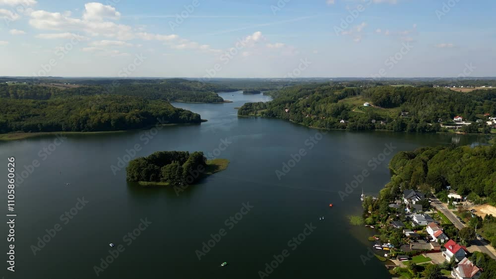 The small island on the Ostrzyckie lake in Kashubia district in Poland. Aerial view. The small island on the Ostrzyckie lake in Kashubia district in Poland. Aerial view.