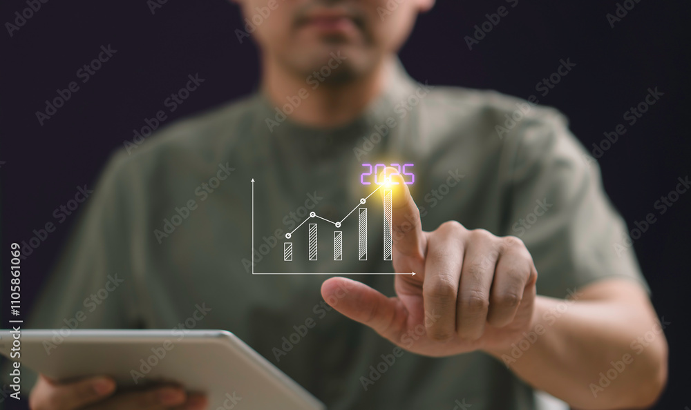 The 2025 New Year business goals concept features a businessman interacting with an upward arrow graph, company growth. It setting strategic targets, and tackling challenges for future success.