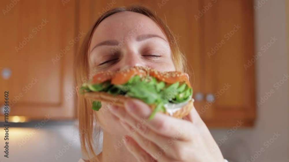 Woman relishes a tasty bite of salmon and avocado toast, enjoying the rich flavors and textures. Happiness shines as she indulges in this nutritious meal, capturing a moment of pure joy Woman relishes a tasty bite of salmon and avocado toast, enjoying the rich flavors and textures. Happiness shines as she indulges in this nutritious meal, capturing a moment of pure joy