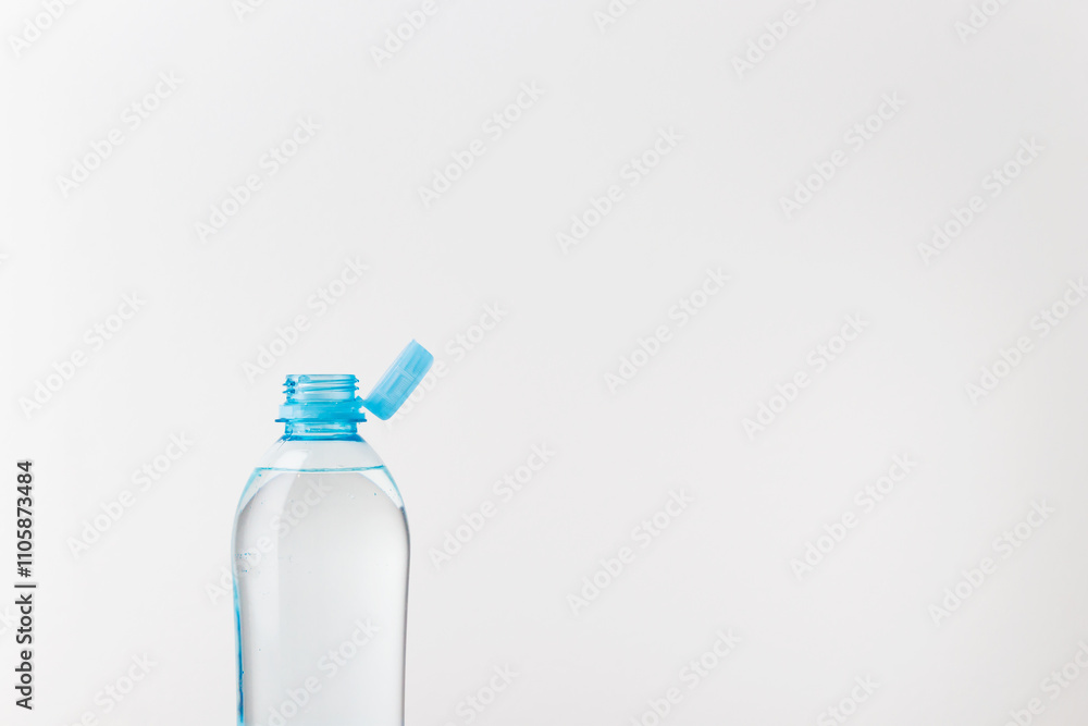 Bottle with a stationary plastic cap on a white background. The new design means the cap remains attached to the bottle after opening Bottle with a stationary plastic cap on a white background. The new design means the cap remains attached to the bottle after opening