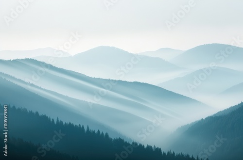 Misty mountain range with serene blue tones.