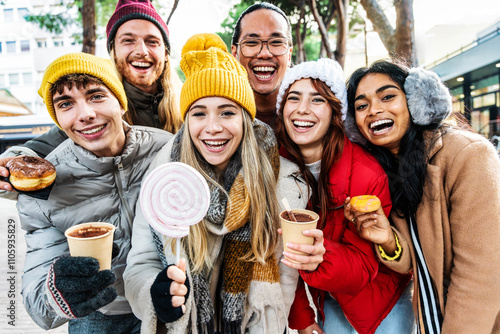 Happy friends wearing winter clothes having fun outside - Smiling young people enjoying winter holiday walking in Christmas market