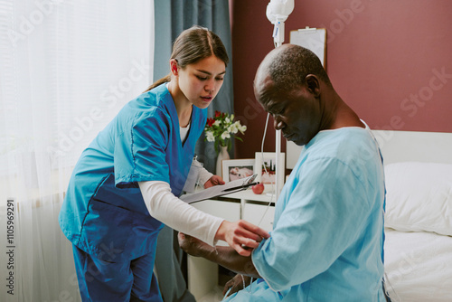 Nurse providing medical care to senior black patient sitting in hospital room with healing equipment and technology around treatment focused on patients arm
