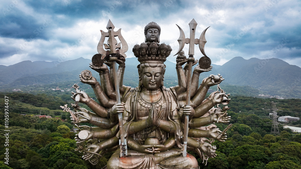 A stunning view of Taiwans Holy Thousand Hand Guanyin statue amid lush mountains A stunning view of Taiwans Holy Thousand Hand Guanyin statue amid lush mountains