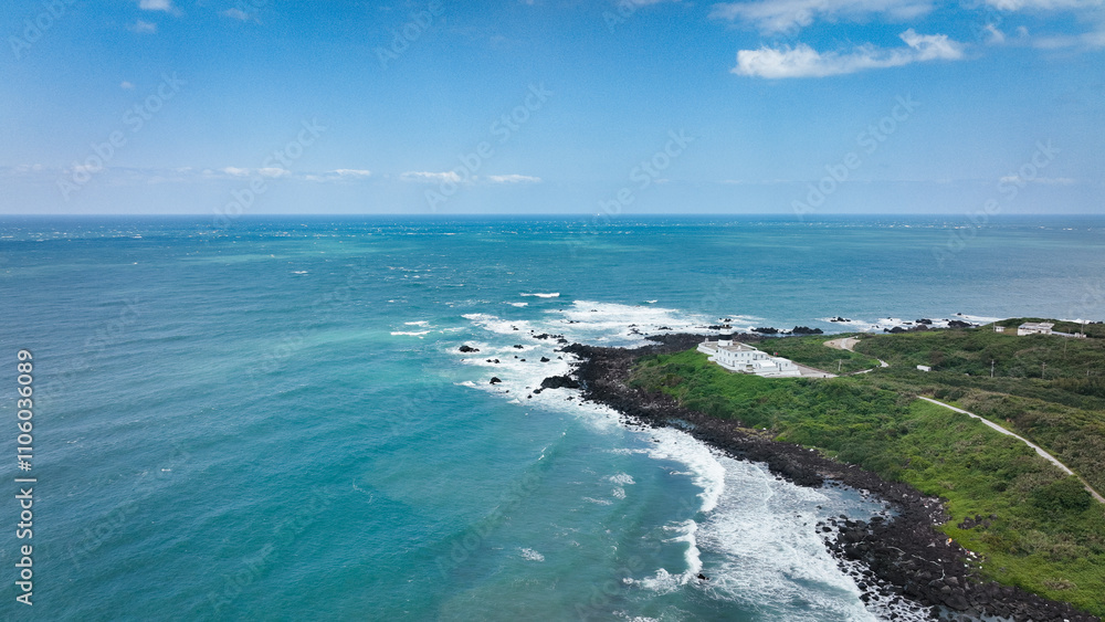 Taiwans stunning coastline boasts clear waters and rocky shores under a bright blue sky Taiwans stunning coastline boasts clear waters and rocky shores under a bright blue sky