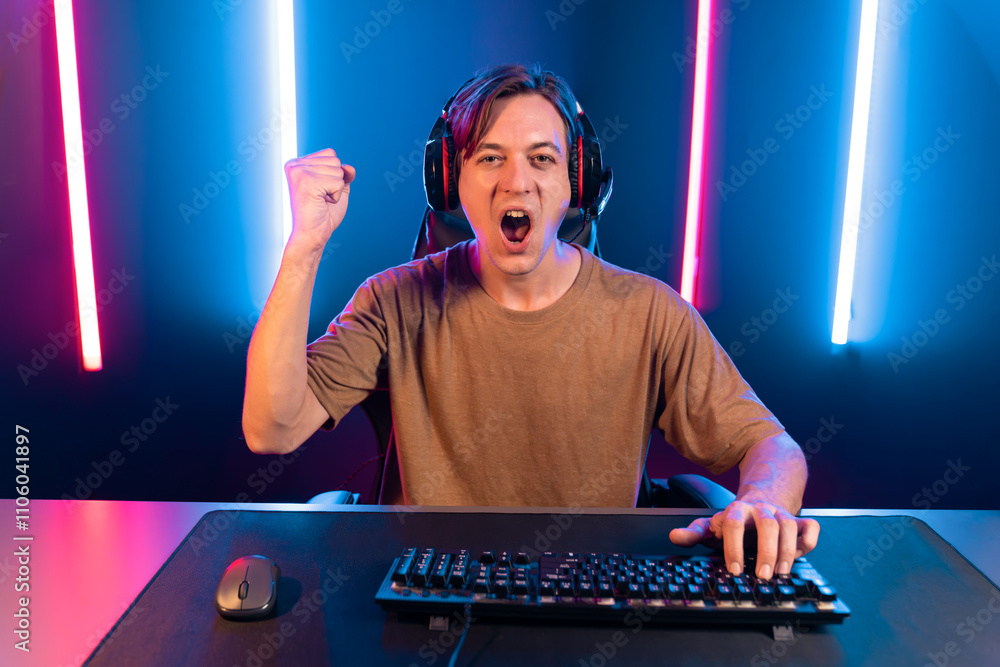 Host channel of gaming smart streamer playing online game to be winner, wearing headphone with viewers live steaming on media social online for selected team competition at neon light room. Pecuniary. Host channel of gaming smart streamer playing online game to be winner, wearing headphone with viewers live steaming on media social online for selected team competition at neon light room. Pecuniary.