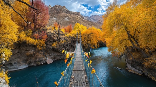 Tibetan Prayer Flag. Colorful Suspension Bridge Crossing the River in Beautiful Autumn Landscape of Stakna Gompa, Leh, Ladakh photo