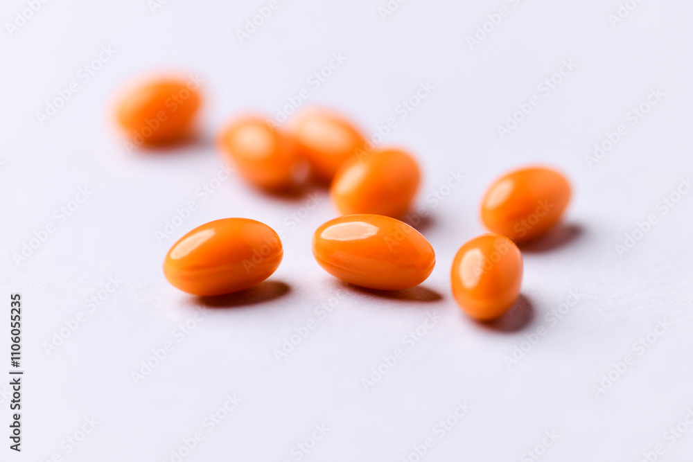 Coenzyme Q10 capsules. Antioxidants. Concept for a healthy dietary supplementation. Bright paper background. Soft focus. Close up. Copy space. Coenzyme Q10 capsules. Antioxidants. Concept for a healthy dietary supplementation. Bright paper background. Soft focus. Close up. Copy space.