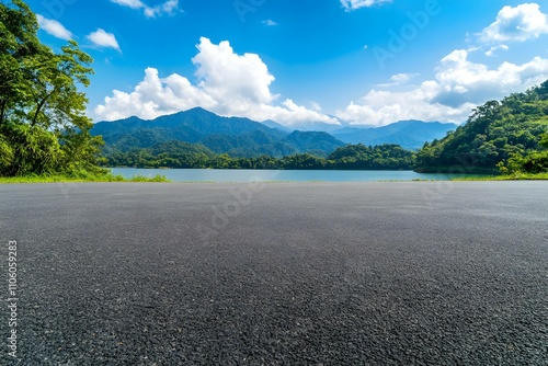 Asphalt road square and clear lake with green mountain