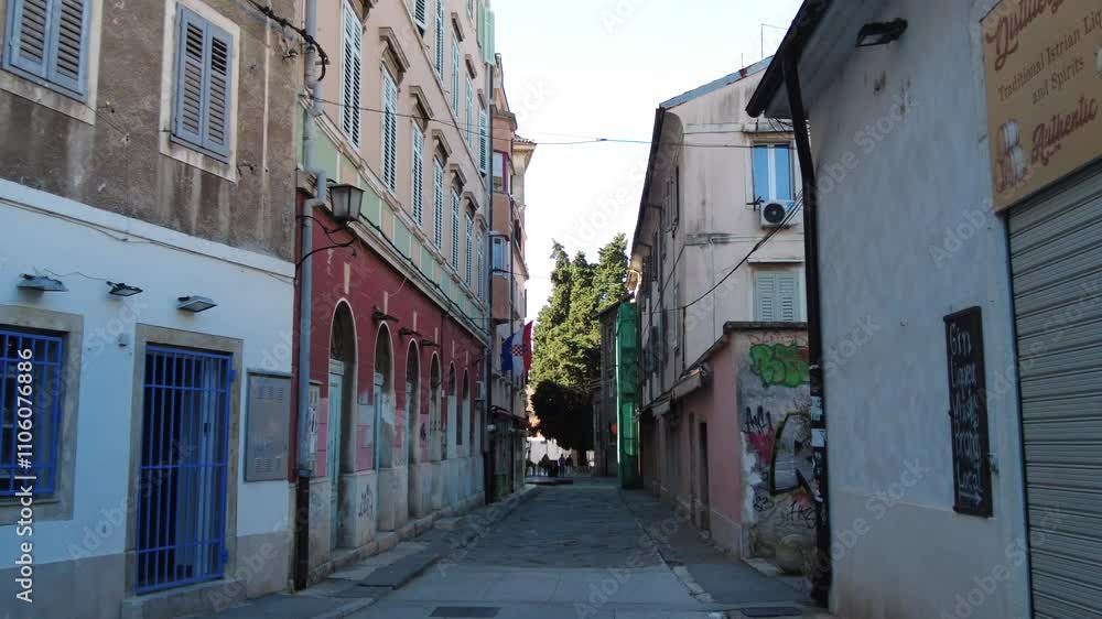 Pula, Croatia - November 3, 2024: View of a city street with houses. The central street of the city. Pula, Croatia - November 3, 2024: View of a city street with houses. The central street of the city.