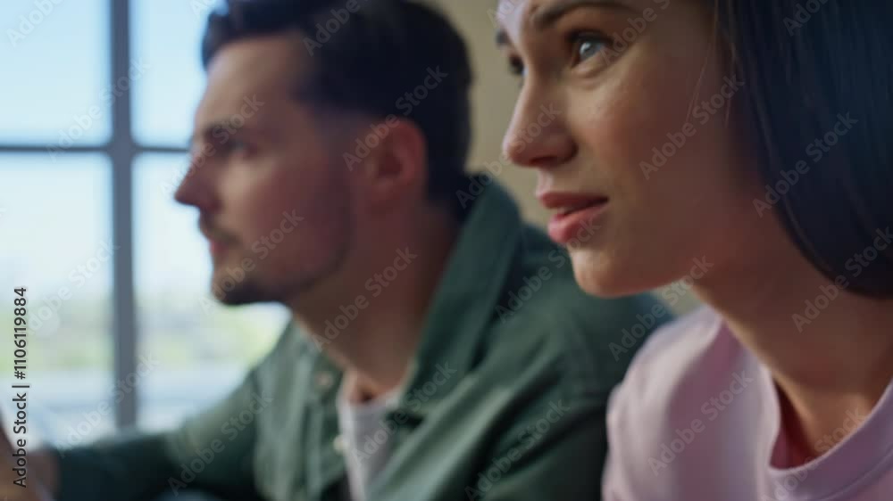 People hands pressing consoles buttons at couch closeup. Guy girl competition People hands pressing consoles buttons at couch closeup. Guy girl competition