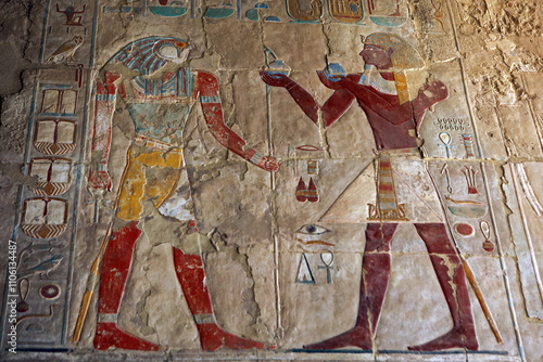 Reliefs of Sokaris (Osiris) and Pharaoh Thutmose III in Mortuary temple of Hatshepsut in Deir el-Bahari, Egypt photo