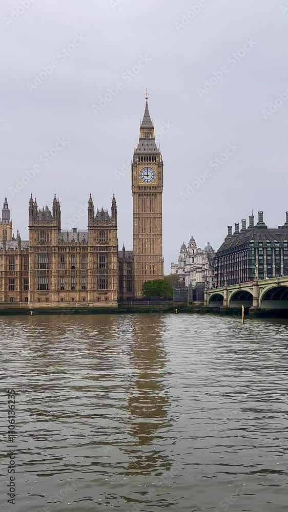 Big Ben and Houses of Parliament stand majestically by the River Thames, framed by Westminster Bridge, slow motion Big Ben and Houses of Parliament stand majestically by the River Thames, framed by Westminster Bridge, slow motion