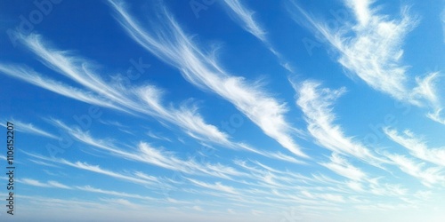 A serene blue sky adorned with wispy white clouds, creating a tranquil atmosphere.