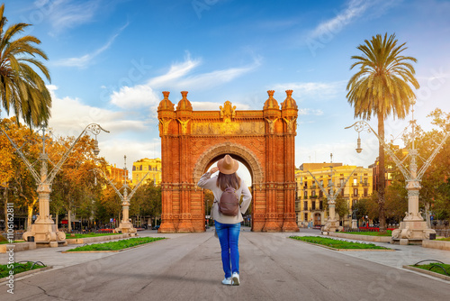 Canvas Print A tourist woman looks at the famous Arc de Triomf in Barcelona, Spain, on her si