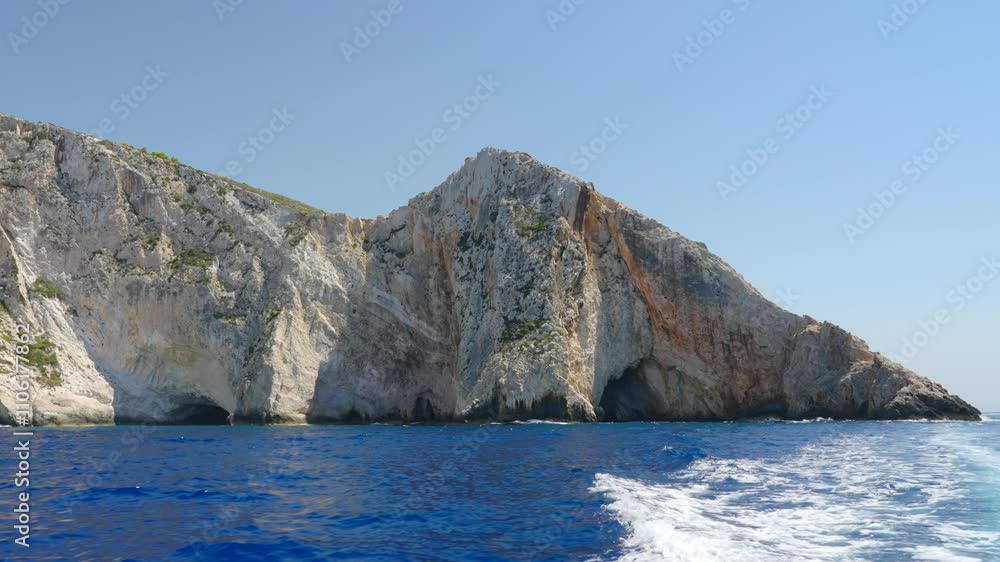 Beautiful view from a motor boat wake sailing in the Ionian Sea in Greece Slow motion shot of blue ocean and white cliffs of Zakynthos island coastline Beautiful view from a motor boat wake sailing in the Ionian Sea in Greece Slow motion shot of blue ocean and white cliffs of Zakynthos island coastline