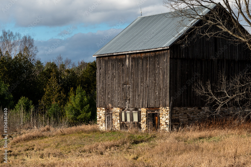 Rural Barn with Metal Roof and Stone Foundation Mid Fall Season Rural Barn with Metal Roof and Stone Foundation Mid Fall Season