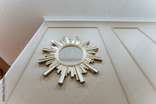 Billede på lærred An Elegant Sunburst Mirror beautifully displayed on a Stylish Wall enhances the