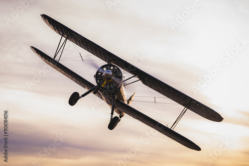 Stearman biPlane flying overhead at sunset