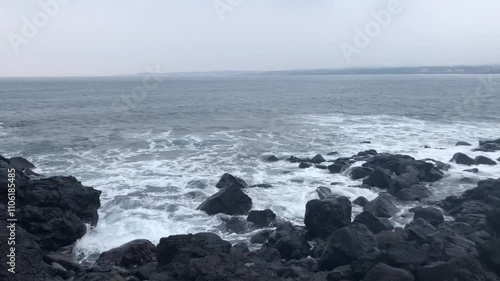 waves crashing on rocks in Jeju, Korea