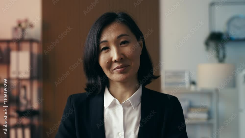 Portrait of a happy Asian female CEO posing in office, successful business owner Portrait of a happy Asian female CEO posing in office, successful business owner